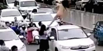 Naked Woman Dances On Top Of Car Causing Traffic Jam