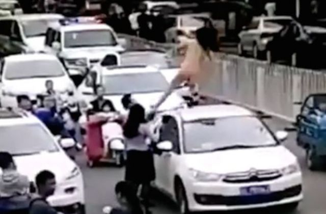 Naked Woman Dances On Top Of Car Causing Traffic Jam